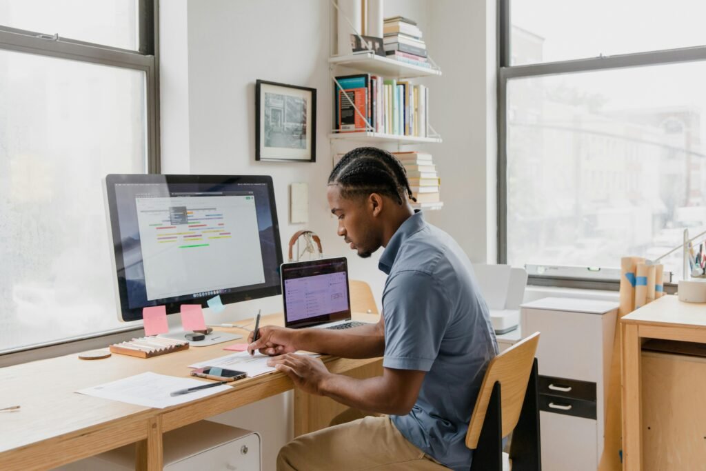 African American man working at a desk in a light-filled modern office.